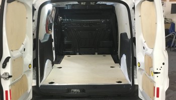 Van with back doors open showing ply lining